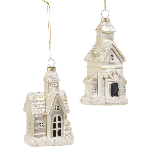 Two white ceramic house ornaments with decorative details on a white background