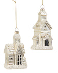 Two white ceramic house ornaments with decorative details on a white background