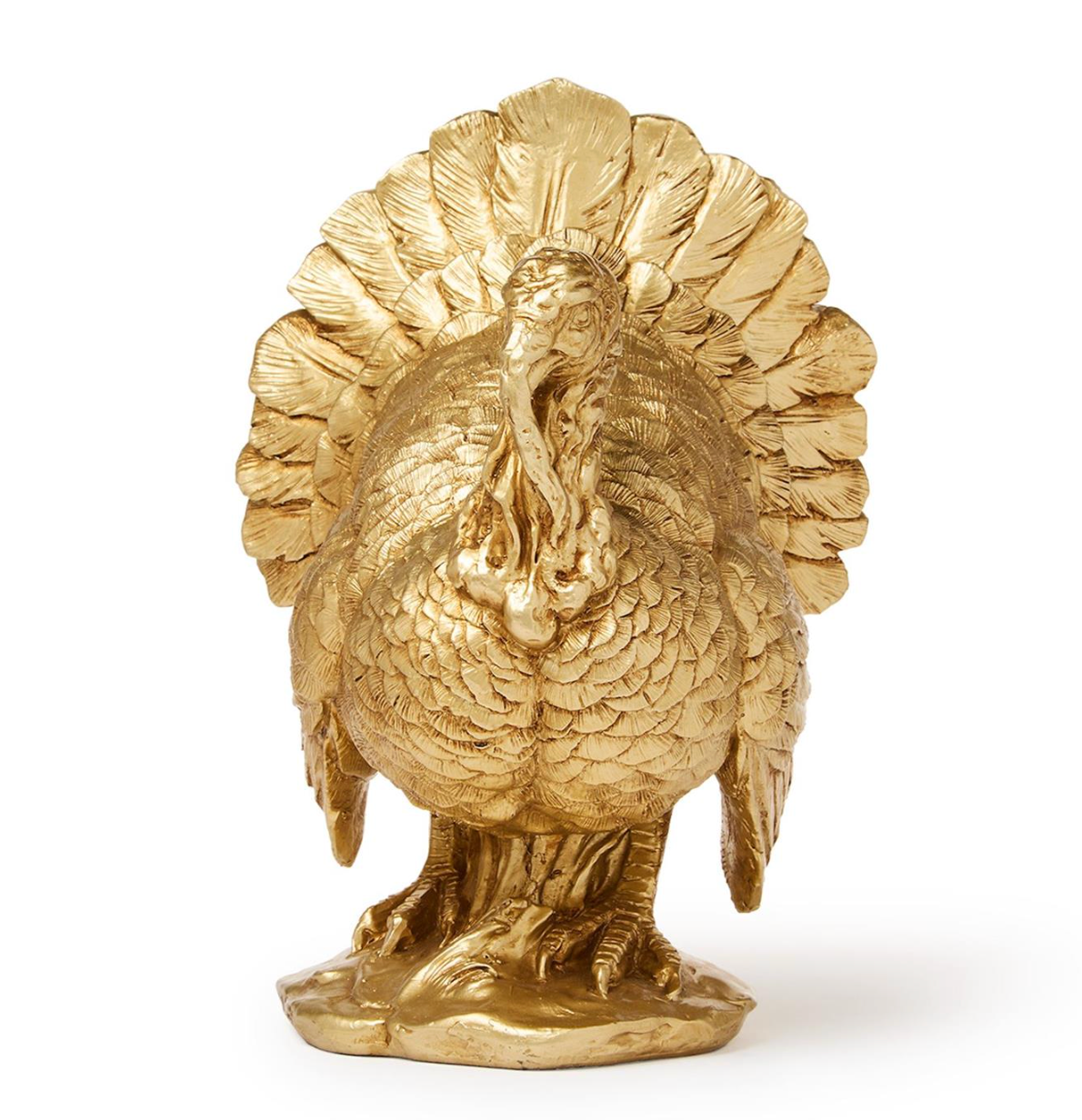 A polished gold-toned metal figurine of a standing turkey with its tail feathers fanned, photographed against a clean white background.
