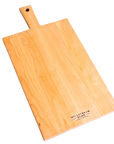 A flat, rectangular wooden cutting board with a natural finish and a logo imprinted on the corner.