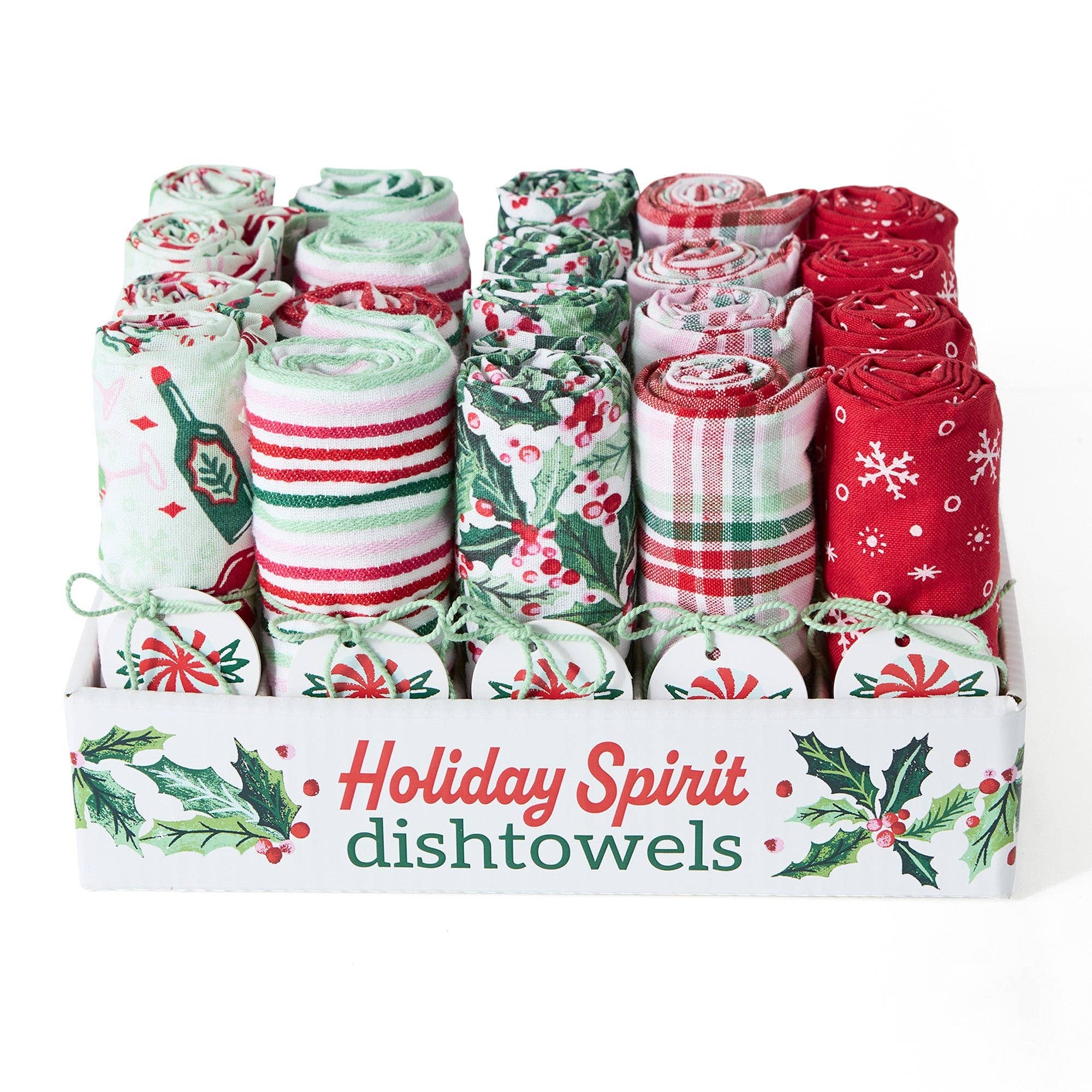 Christmas-themed dishtowels rolled up and arranged in a white display box. The towels feature festive holiday patterns including stripes, holly, snowflakes, and plaid in red, green, and white.