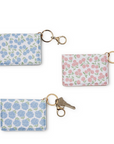 Three hydrangea print wallets with key chains, in different sizes, on a white background.