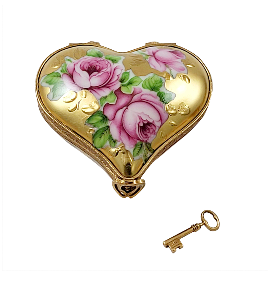 Heart-shaped decorative box with floral design and a key on a white background