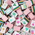 A pile of pink and white Mahjong tiles with colorful Chinese characters and symbols, filling the entire frame.