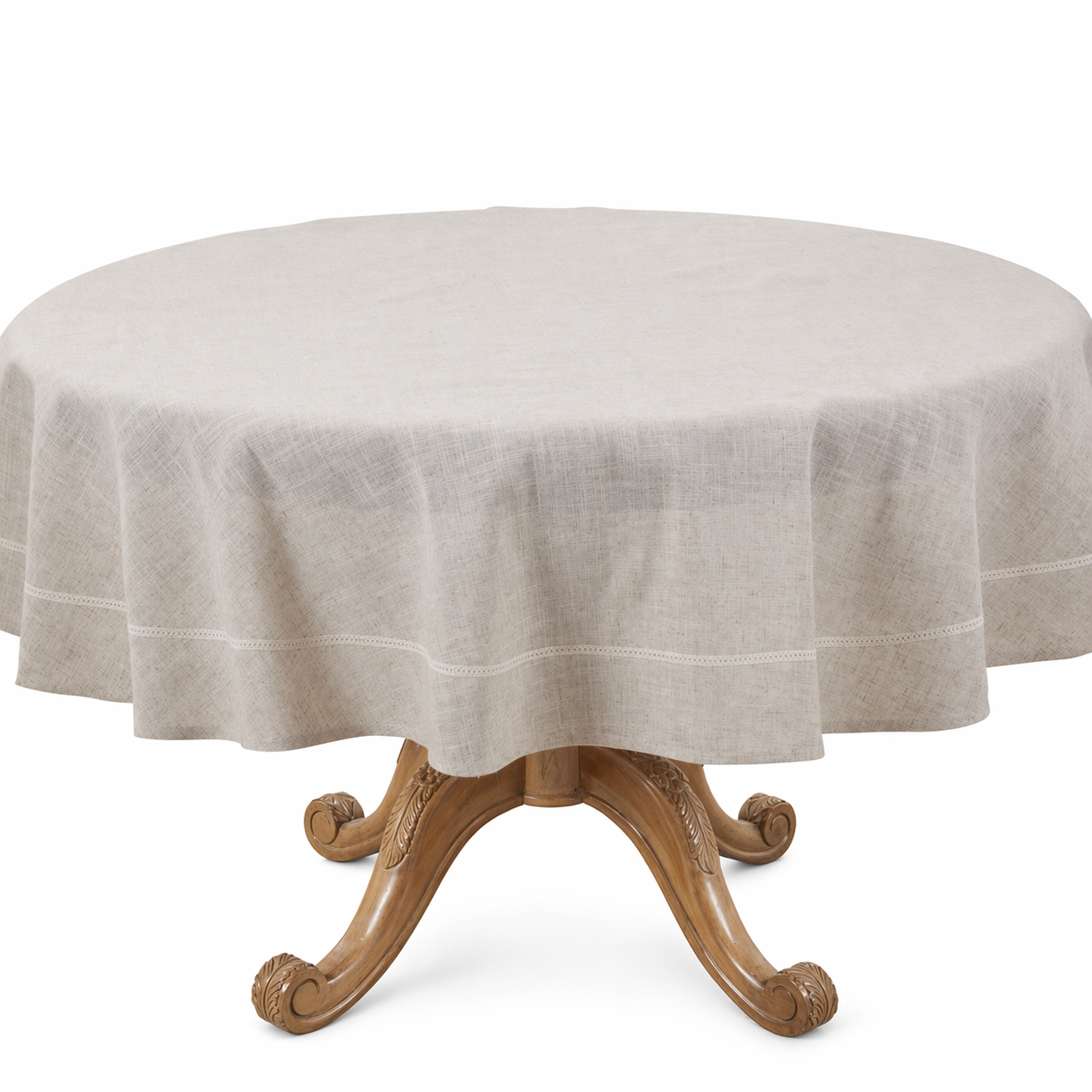 A round dining table covered with a light beige linen tablecloth, set against a plain white background.