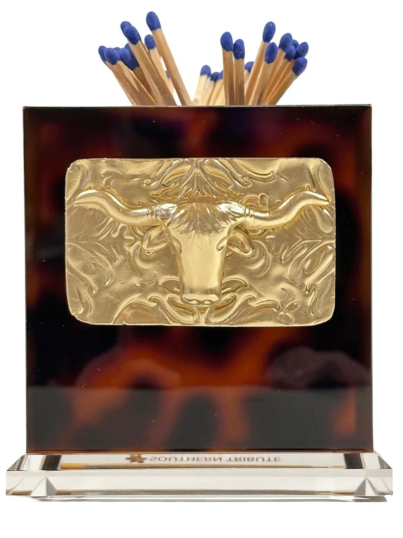 Longhorn Tortoiseshell matchbox with gold bull emblem and blue matches on a white background