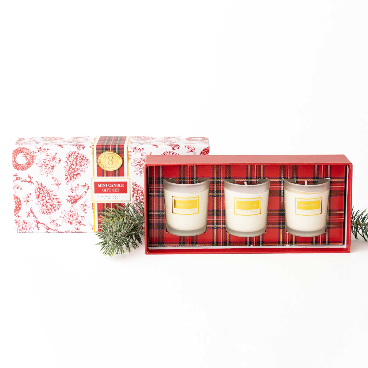 Set of three candles in a decorative box with a plaid pattern on a white background