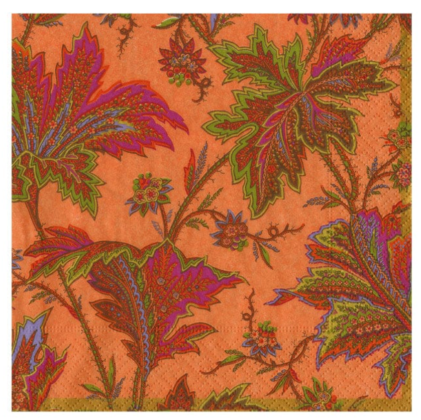 A square patterned napkin with a vibrant orange background and an intricate botanical design featuring leaves and flowers in green, purple, red, and brown.