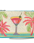 Beaded clutch with cocktail and palm tree design on a white background