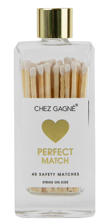 A clear rectangular bottle of Chez Gagné Perfect Match safety matches with a gold cap and white label, showing wooden matches inside.