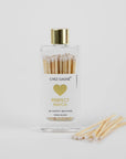 Bottle of matches with a gold cap and heart design on a white background