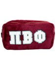 Maroon pouch with white and blue Pi Phi letters on a white background
