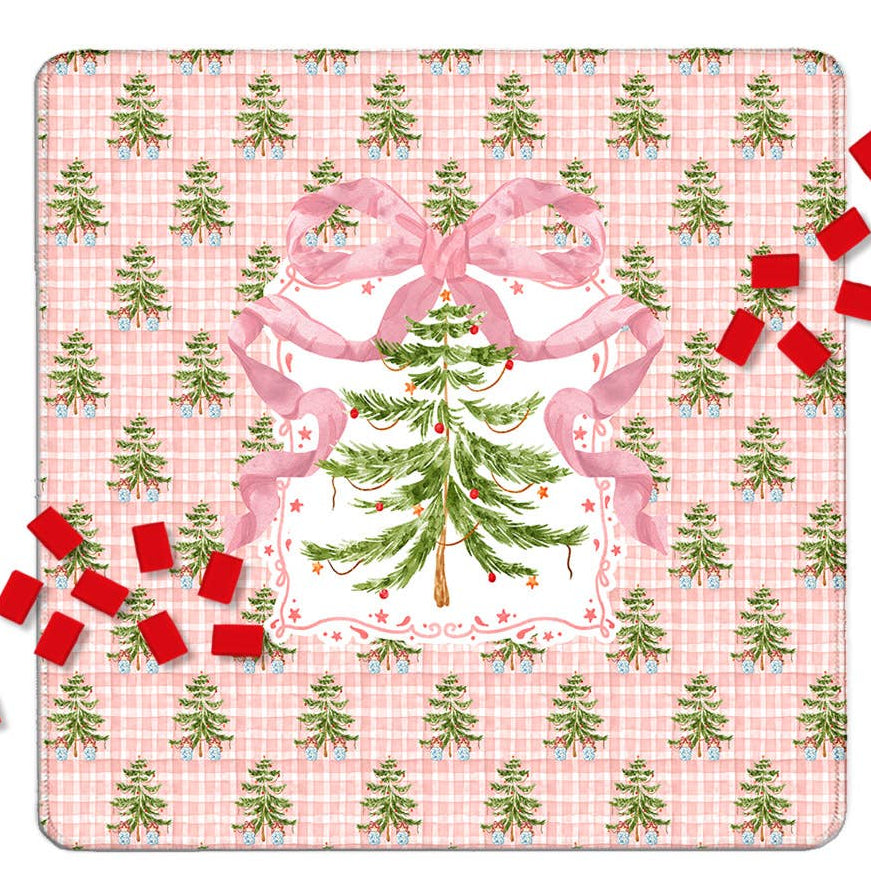 A square Mahjong mat design featuring a pink gingham background with a repeating pattern of small green Christmas trees, a large central green Christmas tree framed by pink ribbons, and scattered red gift boxes around it.