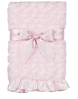 Pink textured blanket with a large bow on a white background