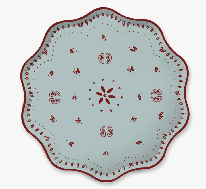 A scalloped paper plate with a light blue-gray glaze and a dark red hand-painted folk pattern, shown from a top-down view on a white background.