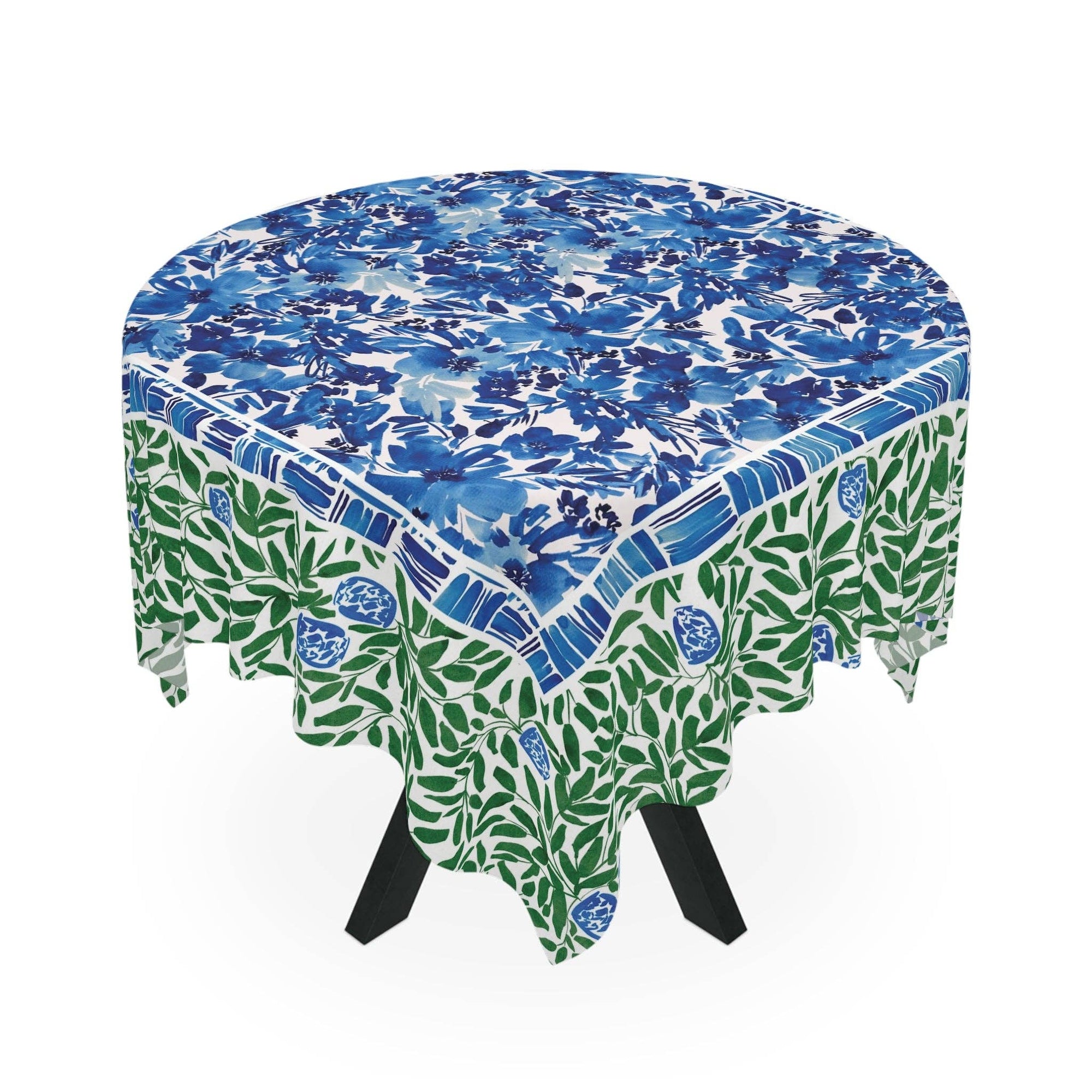 Round table with a blue and green floral patterned tablecloth on a white background