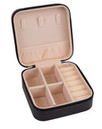 Black jewelry case with beige interior on a white background