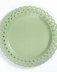 Light green paper plate with decorative lace edge on a white background