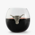 A stemless wine glass filled with red wine, featuring a solid pewter longhorn design attached to the glass as a decoration.