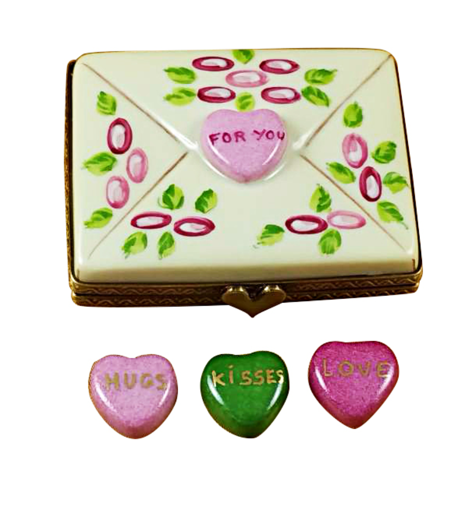 Decorative box with heart-shaped candies and 'For You' message, accompanied by three additional heart-shaped candies.