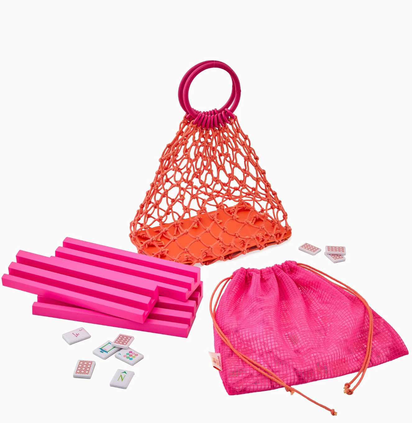 Pink and orange children's Mahjong set with sticks, dice, and bags on a white background