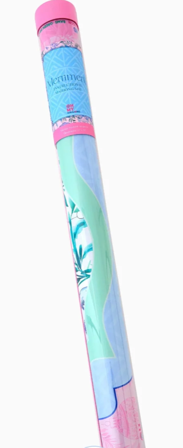 A rolled-up mahjong mat featuring pastel shades of mint green, light blue, and pink, wrapped in clear plastic with a pink and blue plasic tube