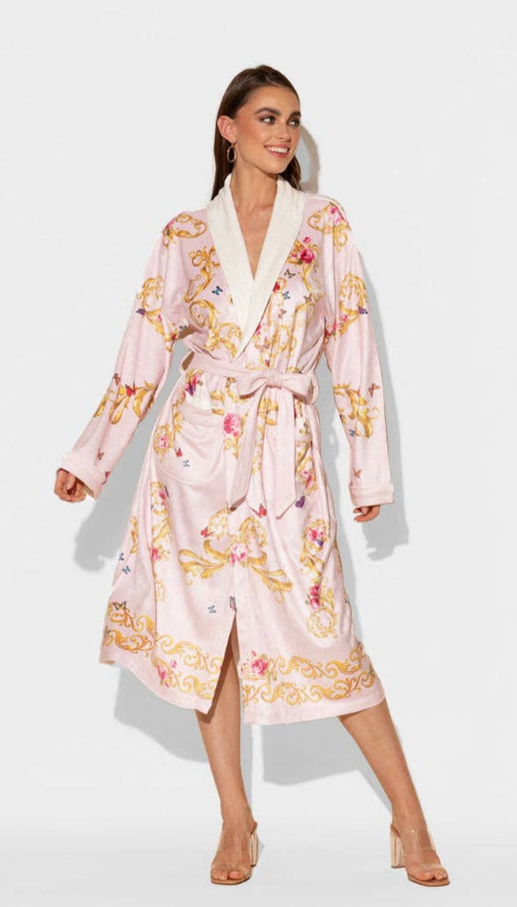 Woman wearing a pink floral robe on a white background