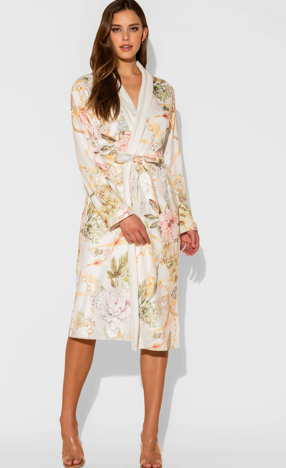 Woman wearing a floral dress against a white background