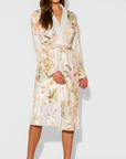 Woman wearing a floral dress against a white background