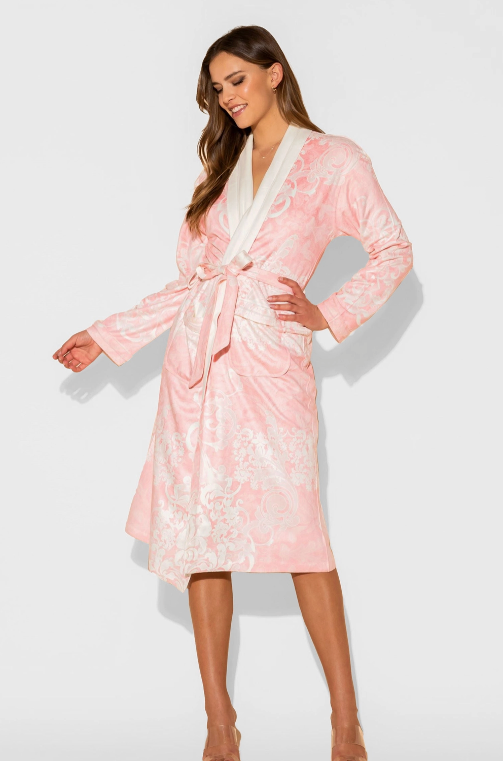 Woman wearing a pink floral robe on a white background