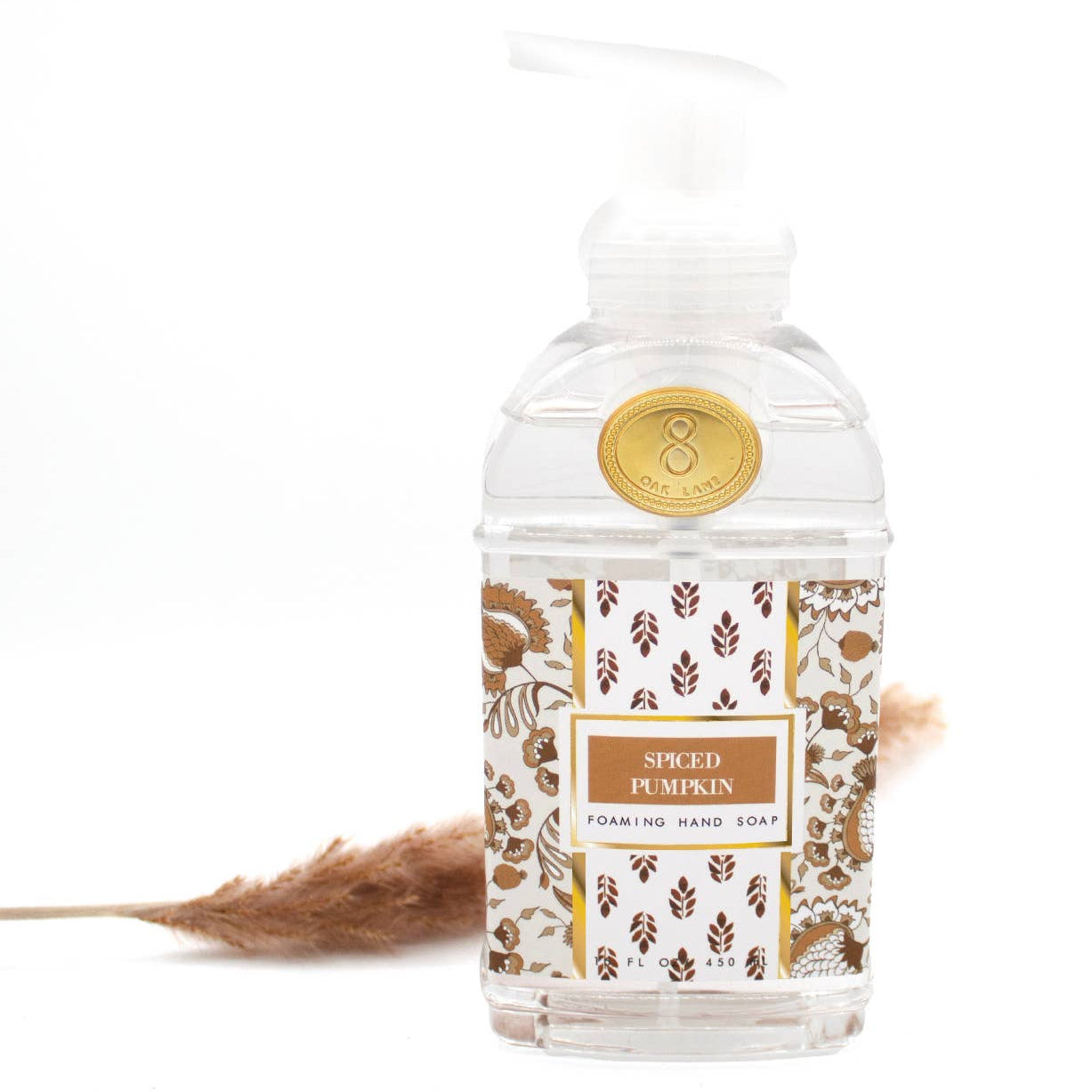 Foaming hand soap bottle with decorative label on a white background