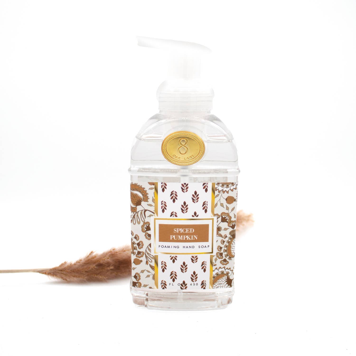 Foaming hand soap bottle with decorative label on a white background
