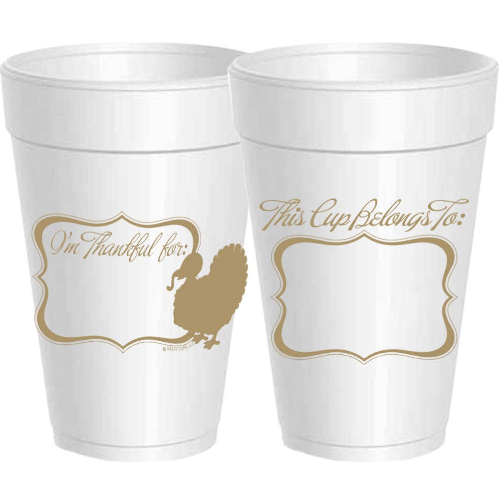 White foam party cups with gold printed Thanksgiving-themed text and turkey silhouettes, shown on a plain white background.