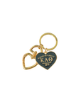 Gold and black keychain with 'Please Return to Kappa Alpha Theta' text on a white background