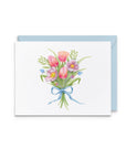 A square white greeting card with a watercolor bouquet of pink tulips, purple flowers, green leaves, and a blue ribbon, shown with a light blue envelope behind it on a white background.