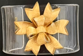 Gold bow on a clear acrylic cuff