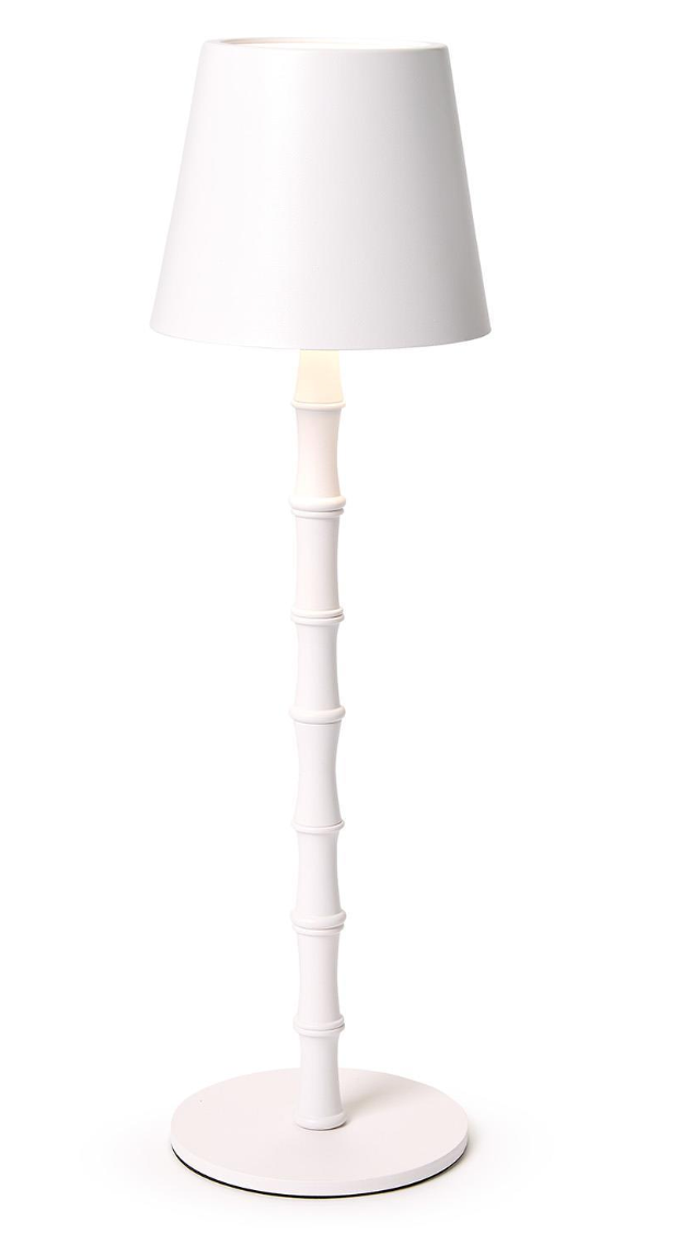 A white cordless table lamp with a scalloped edge shade, featuring an illuminated top part and a rechargeable battery base.