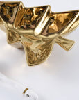 Gold serving bowl shaped like a Christmas tree on a white background