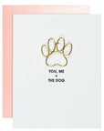 Card with gold paw print and text 'You, Me + The Dog' on a white background with pink border