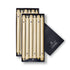 A set of light yellow unscented taper candles presented in a black box with the brand name 'Colonial Candle' visible on the packaging.
