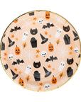 Round paper plate with Halloween-themed pattern on a light orange background