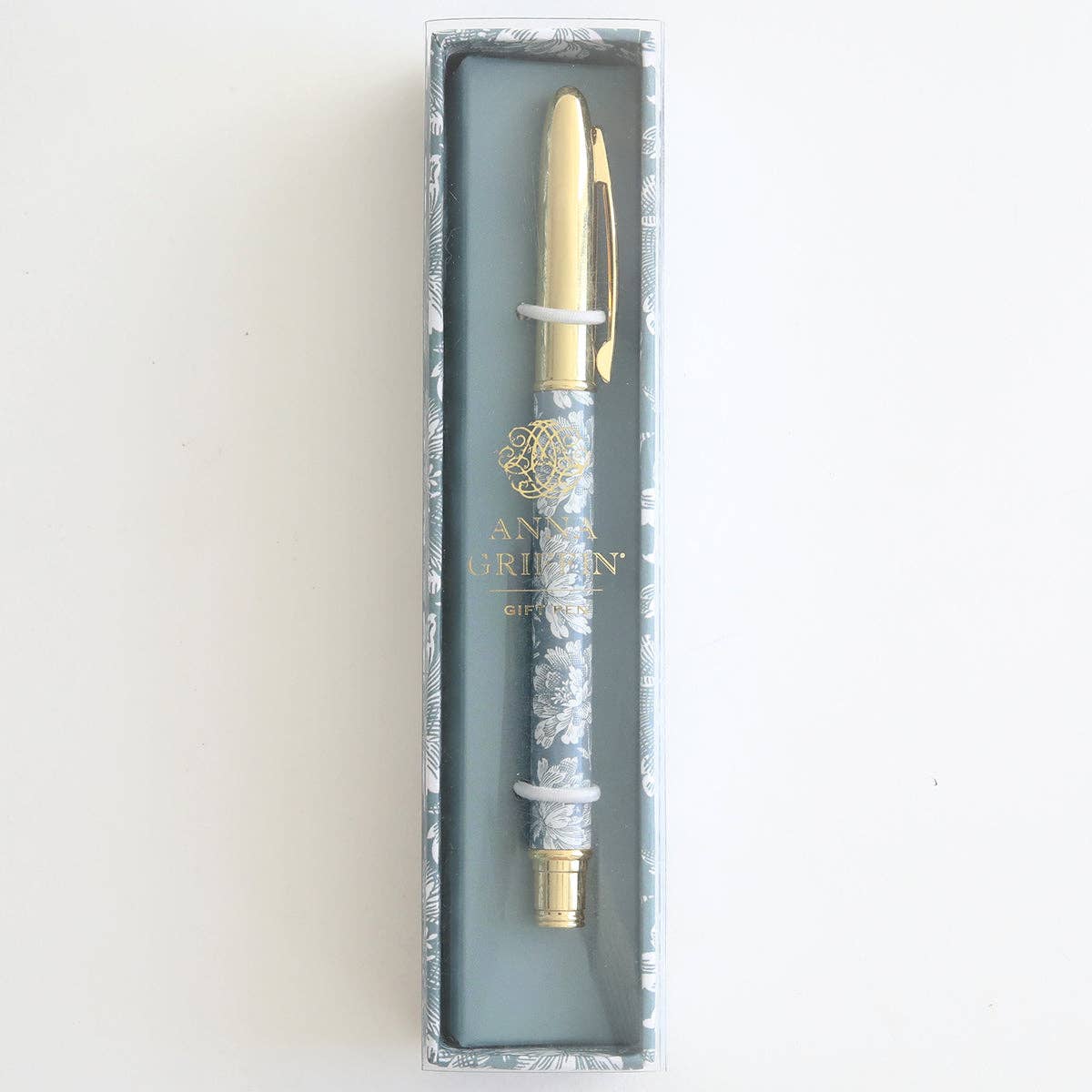 Pen with decorative cap in a branded box on a light background