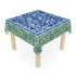 Table with a floral patterned tablecloth on a white background