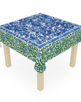 Table with a floral patterned tablecloth on a white background