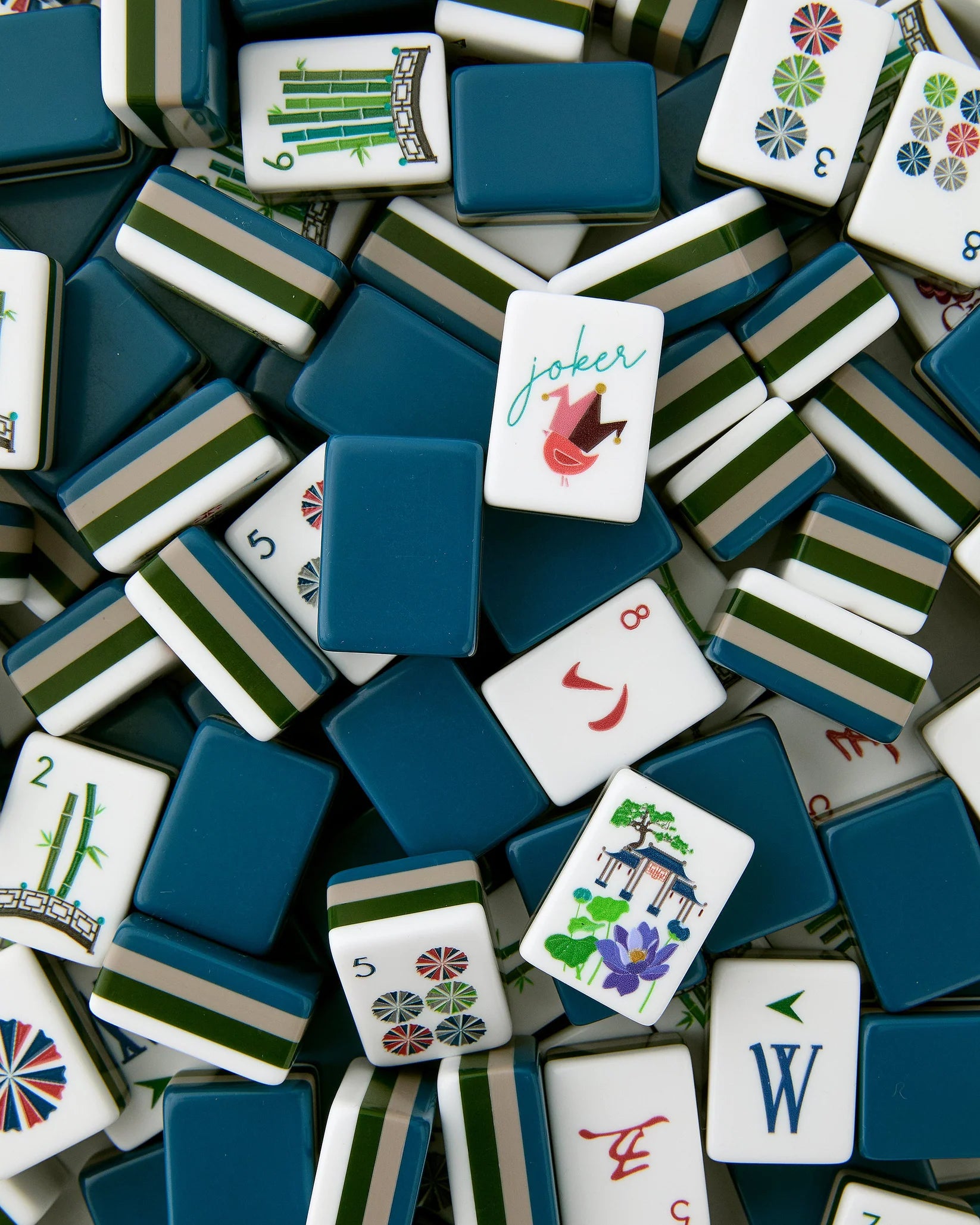 Collection of assorted mahjong tiles with various designs and colors.