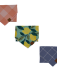 A set of three dog bandanas in different patterns and colors, displayed on a white background.